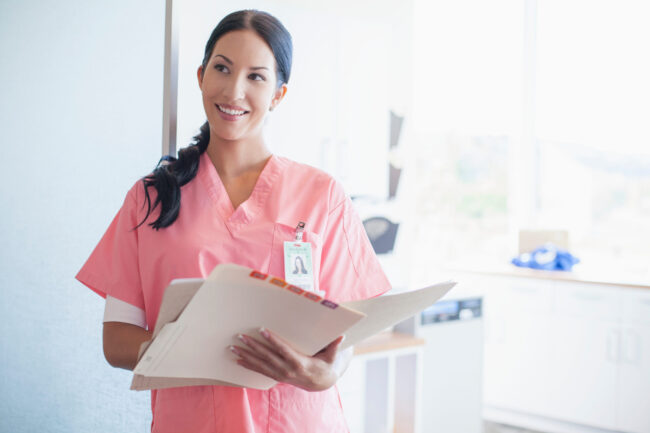 pretty nurse, holding medical charts